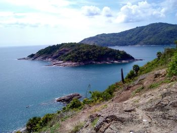 Scenic view of sea and mountains against sky
