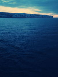 Scenic view of sea against sky at sunset