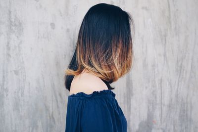 Close-up of woman against wall