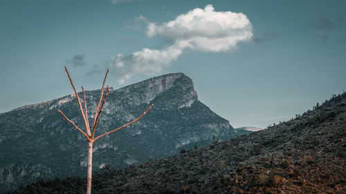 Low angle view of lightning over mountain against sky