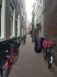 Bicycles parked on street amidst buildings in city
