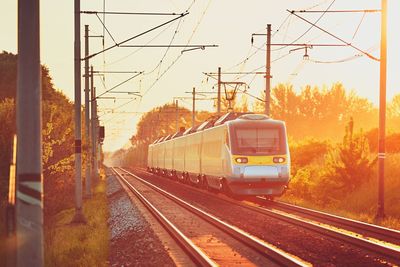 Train on railroad tracks against clear sky