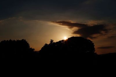 Silhouette of trees against sky at sunset