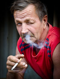 Close-up of man smoking cigarette