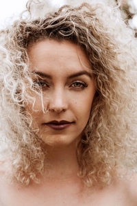 Portrait of young woman with curly hair