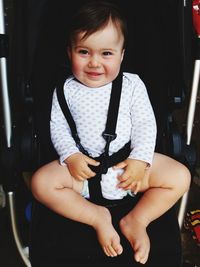 Portrait of cute boy baby sitting on seat