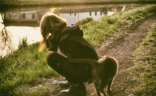 Woman with dog on field