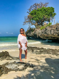 Full length portrait of man standing on beach