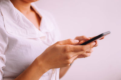 Midsection of woman using mobile phone