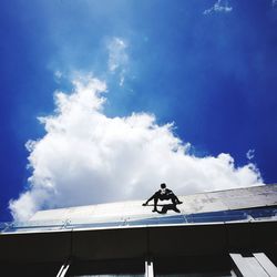 Low angle view of airplane against blue sky