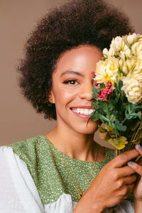 Portrait of young woman with bouquet