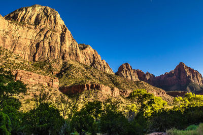 Low angle view of mountain against blue sky