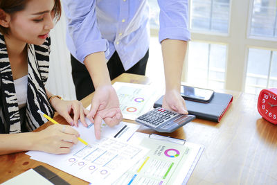 High angle view of people working on table