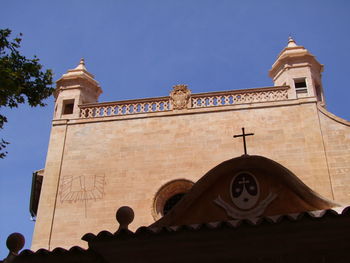 Low angle view of bell tower against sky