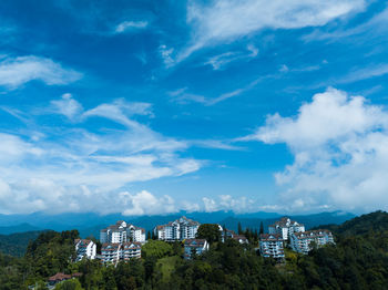 Low angle view of buildings against cloudy sky