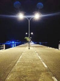 View of illuminated street lights at night