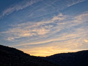 Low angle view of silhouette mountain against sky