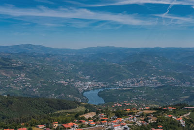 High angle view of river by mountains against sky