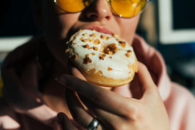 Close-up of woman eating donut