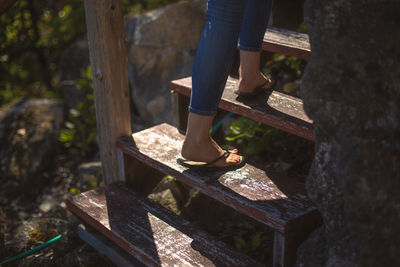 Low section of woman standing on wood