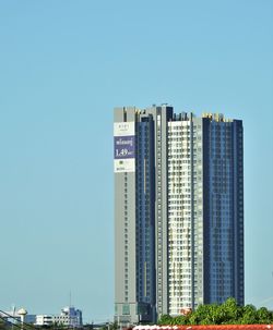 Modern buildings against clear blue sky