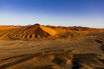 Scenic view of desert against clear sky