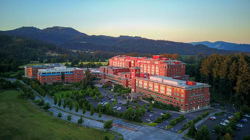 Aerial view of a red brick hospital at sunset