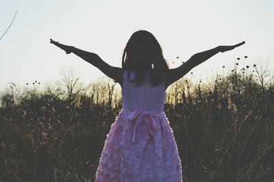 Silhouette of woman standing on field