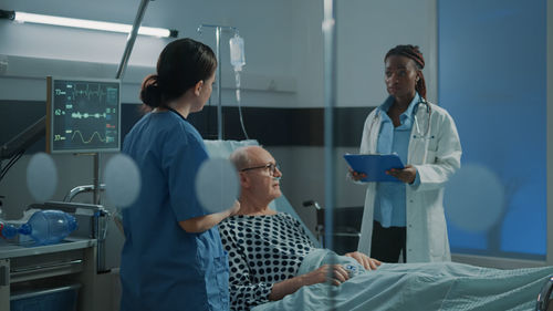 Nurse and doctor examining patient