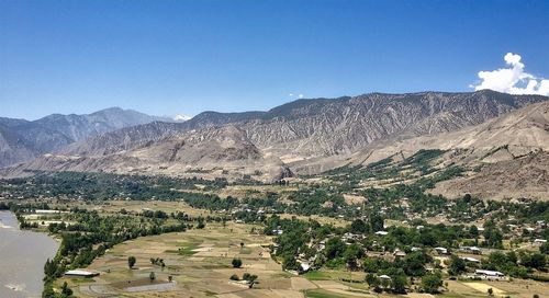 Scenic view of mountains against clear blue sky