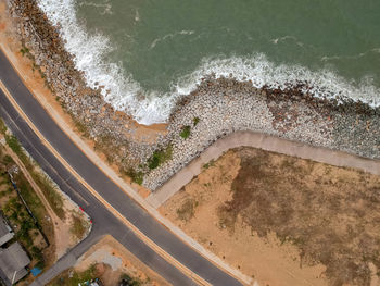 Aerial view of road by sea