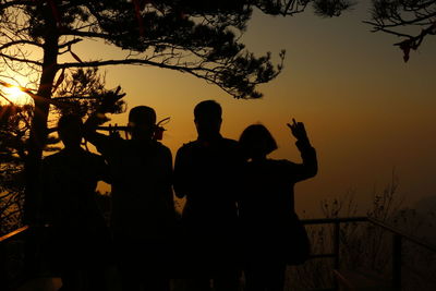 Low angle view of silhouette people against sky during sunset