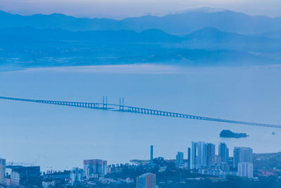 View of suspension bridge with city in background