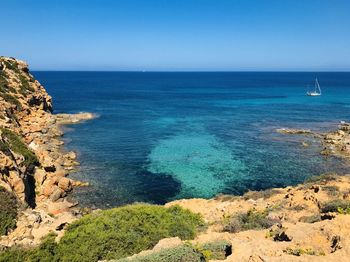 Scenic view of sea against clear blue sky
