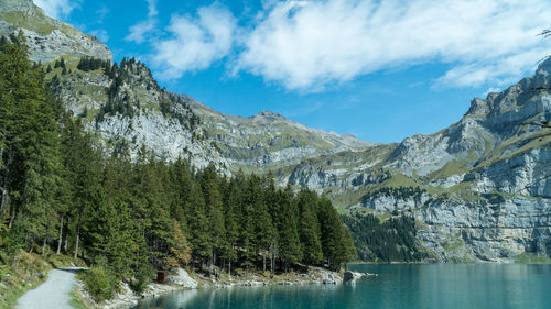 Scenic view of lake by trees against sky