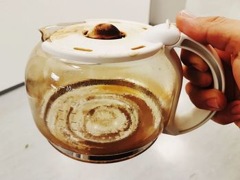 Close-up of hand holding coffee cup