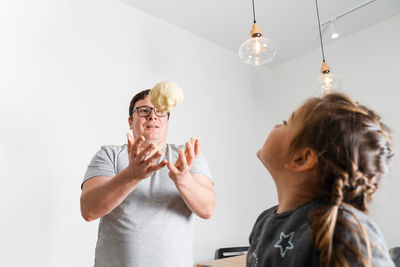 Side view of woman with balloons against white background