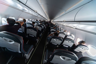 Rear view of people sitting in airplane