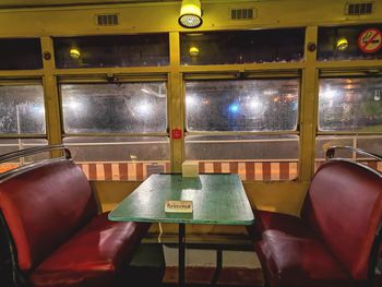 Empty chairs and tables in train