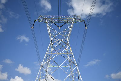 Low angle view of electricity pylon against sky