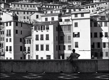 Rear view of woman standing on building terrace