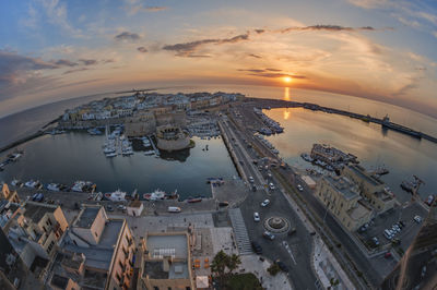 High angle view of buildings and city against sky during sunset