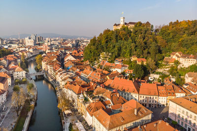 High angle view of townscape by river in city