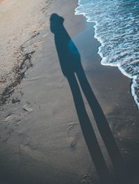 Shadow of person on beach