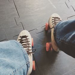 Low section of woman standing on tiled floor