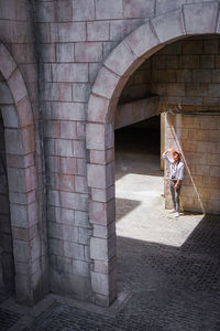 Full length of woman standing against building