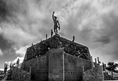 Low angle view of statue against cloudy sky