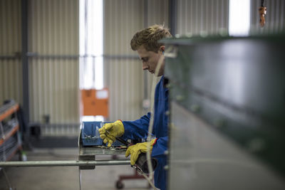 Factory worker in truck manufacture assembling truck parts