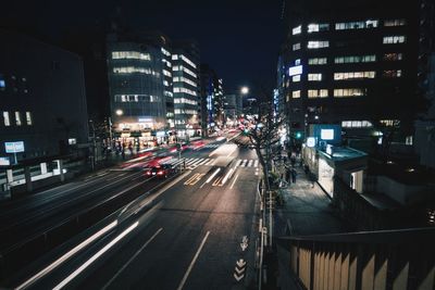 View of city street and buildings at night