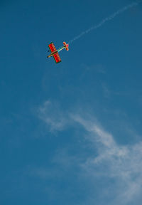 Low angle view of airplane flying in sky